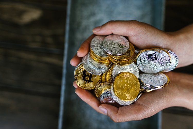 Person Holding Gold and Silver Crypto Coins