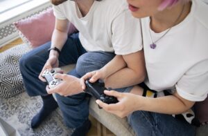 Cute couple playing videogames on the couch