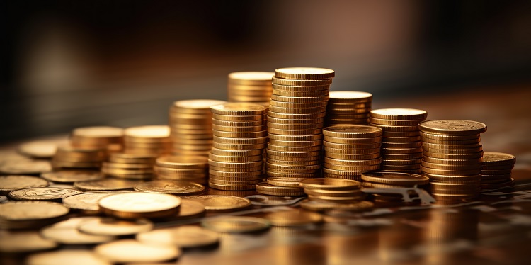 A stack of coins with a financial chart behind